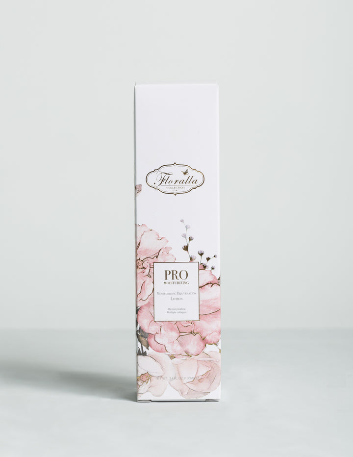 Floralla Pro Moisturizing Rejuvenation Lotion, in white cardboard box packagin with pink floral designs and gold accents.