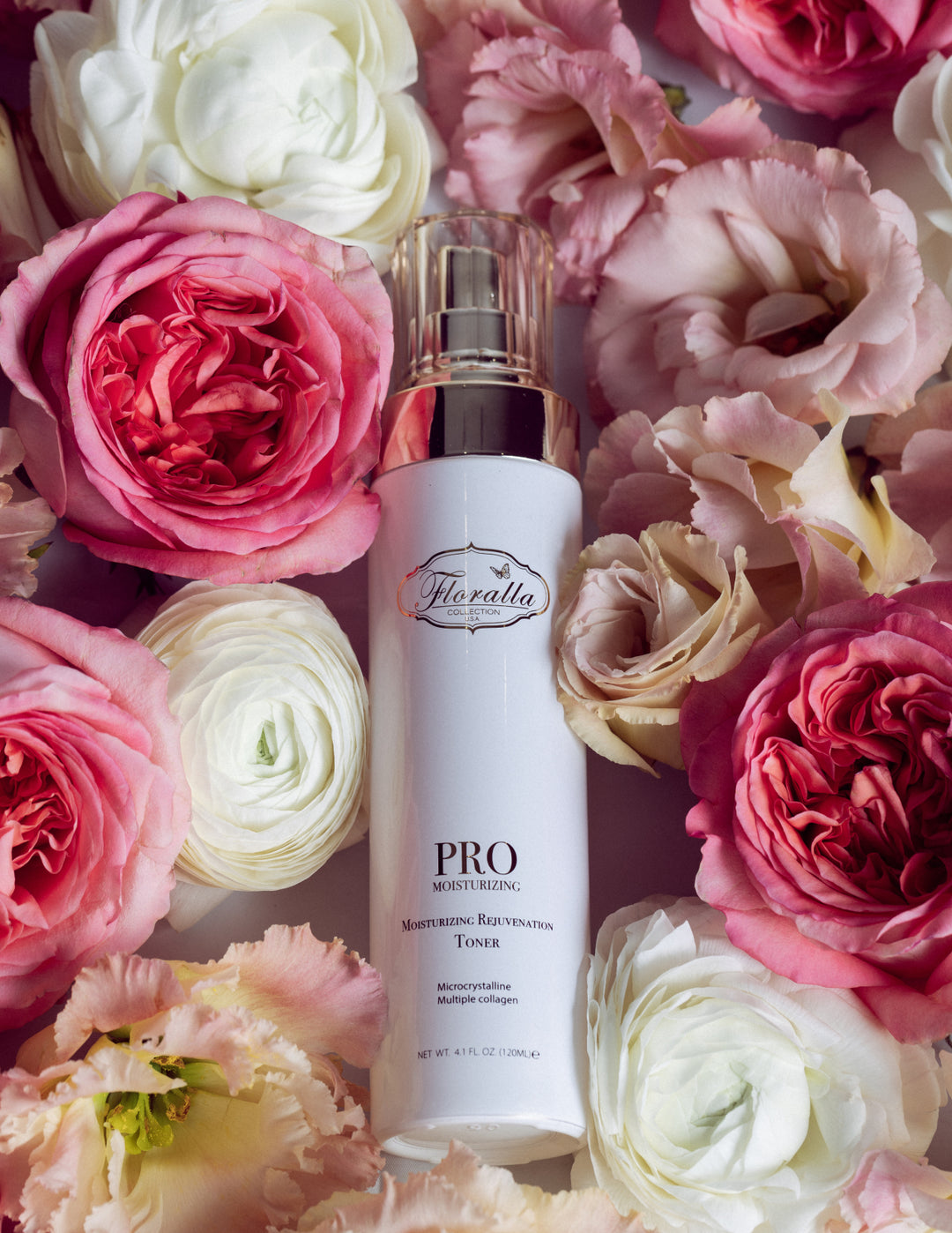Floralla Pro Moisturizing Rejuvenation Toner, in white bottle with gold accents, surrounded by pink and white roses.